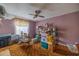 A small bedroom features pink walls, carpeted floors, and a ceiling fan at 465 Ne 155Th Street Rd, Citra, FL 32113