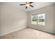 Neutral carpeted bedroom with ceiling fan, window and natural light at 465 Ne 155Th Street Rd, Citra, FL 32113