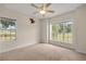 Bright bedroom with large windows offering outdoor views, carpeted flooring, and neutral paint at 465 Ne 155Th Street Rd, Citra, FL 32113