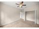 Bedroom with closet and entry to bathroom, ceiling fan and neutral carpet at 465 Ne 155Th Street Rd, Citra, FL 32113