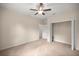Bedroom with closet and entry to bathroom, ceiling fan and neutral carpet at 465 Ne 155Th Street Rd, Citra, FL 32113