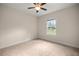 Neutral carpeted bedroom with ceiling fan, window and natural light at 465 Ne 155Th Street Rd, Citra, FL 32113
