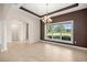 Bright dining room with a large window showcasing the backyard and mature trees at 465 Ne 155Th Street Rd, Citra, FL 32113