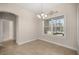 Dining room with tile floors, neutral walls, large window, and modern chandelier at 465 Ne 155Th Street Rd, Citra, FL 32113