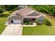 Charming exterior of home featuring a well-manicured lawn and attached two-car garage at 465 Ne 155Th Street Rd, Citra, FL 32113