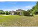Charming home with mature landscaping, manicured lawn, and large driveway at 465 Ne 155Th Street Rd, Citra, FL 32113