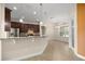 Open-concept kitchen with dark cabinetry, modern fixtures, and a bar overlooking the dining area at 465 Ne 155Th Street Rd, Citra, FL 32113