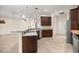 Open concept kitchen with breakfast bar featuring granite countertops and stainless steel appliances at 465 Ne 155Th Street Rd, Citra, FL 32113