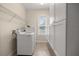 Laundry room with washer, dryer, storage cabinets and tile flooring at 465 Ne 155Th Street Rd, Citra, FL 32113