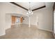 Spacious living room featuring tile floors, chandelier, and archways to other living spaces at 465 Ne 155Th Street Rd, Citra, FL 32113