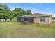 The rear exterior shows a screened lanai and a spacious backyard at 465 Ne 155Th Street Rd, Citra, FL 32113