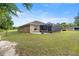 The rear exterior highlights a screened lanai and outdoor patio, perfect for entertaining guests at 465 Ne 155Th Street Rd, Citra, FL 32113