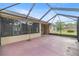 The screen enclosed patio enhances outdoor living at 465 Ne 155Th Street Rd, Citra, FL 32113