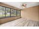 Sun room with ceiling fan, outdoor view, and wood look flooring at 465 Ne 155Th Street Rd, Citra, FL 32113
