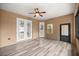Sun room with multiple windows and doors, ceiling fan, and wood look flooring at 465 Ne 155Th Street Rd, Citra, FL 32113