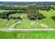 Aerial view of home and barn with fenced pasture on expansive lot at 5330 Ne 111Th Lane Rd, Anthony, FL 32617