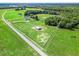 Aerial view of the expansive property with barn, home, pasture, and horse fencing at 5330 Ne 111Th Lane Rd, Anthony, FL 32617