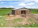 Exterior shot of barn with wood siding and metal roof against bright-green pasture at 5330 Ne 111Th Lane Rd, Anthony, FL 32617
