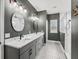 This bathroom features dual sinks, patterned floors, modern lighting and a walk-in shower at 5330 Ne 111Th Lane Rd, Anthony, FL 32617