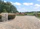 Community entrance with stone pillars, gate, pavers and professional landscaping at 5330 Ne 111Th Lane Rd, Anthony, FL 32617