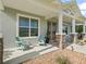 Inviting front porch with decorative chairs and stone pillar accents at 5330 Ne 111Th Lane Rd, Anthony, FL 32617