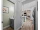 Hallway view of the half bath, kitchen, living room and dining room with luxury vinyl plank flooring at 5330 Ne 111Th Lane Rd, Anthony, FL 32617