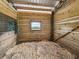 Horse stall with wood walls, window with pasture view, and fresh wood shavings at 5330 Ne 111Th Lane Rd, Anthony, FL 32617