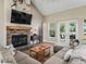 Cozy living room featuring a stone fireplace and comfortable seating at 5330 Ne 111Th Lane Rd, Anthony, FL 32617