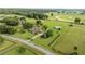 An aerial view of a sprawling property with a well-maintained home, lush greenery, and equestrian amenities at 5661 Nw 96Th Ln, Ocala, FL 34482