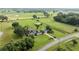 Aerial view of sprawling estate with home, equestrian facilities, and lush greenery at 5661 Nw 96Th Ln, Ocala, FL 34482
