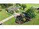 Aerial view of home with long driveway, lush landscaping, and well-manicured lawn at 5661 Nw 96Th Ln, Ocala, FL 34482