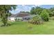Lush backyard featuring a large, screened-in lanai and mature trees at 5661 Nw 96Th Ln, Ocala, FL 34482
