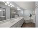 Bathroom featuring double vanity sinks, bathtub, stand up shower, and plenty of light at 5661 Nw 96Th Ln, Ocala, FL 34482