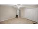Bedroom featuring closets and a ceiling fan at 5661 Nw 96Th Ln, Ocala, FL 34482