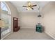 Spacious bedroom with neutral walls, carpet and a large window bringing in natural light at 5661 Nw 96Th Ln, Ocala, FL 34482