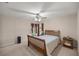 Bedroom featuring a ceiling fan, window, and bed at 5661 Nw 96Th Ln, Ocala, FL 34482