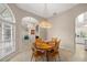 Charming dining room with wooden table, traditional chairs, decorative chandelier, and a view of the kitchen at 5661 Nw 96Th Ln, Ocala, FL 34482