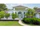 Stunning exterior view showcases a home's arched entryway, well-manicured landscaping, and welcoming walkway at 5661 Nw 96Th Ln, Ocala, FL 34482