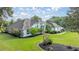 Well-manicured lawn with charming single-story home with fresh landscaping and a welcoming walkway at 5661 Nw 96Th Ln, Ocala, FL 34482
