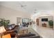 Bright and airy living room with tile floors, ceiling fans, and sliding doors to an enclosed patio at 5661 Nw 96Th Ln, Ocala, FL 34482