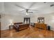 Serene main bedroom with hardwood floors, ceiling fan, and soft, neutral color palette at 5661 Nw 96Th Ln, Ocala, FL 34482