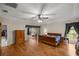 Spacious main bedroom featuring wood floors, ceiling fan, and access to the lanai at 5661 Nw 96Th Ln, Ocala, FL 34482