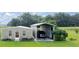 View of outbuilding with metal awning over a large vehicle at 5661 Nw 96Th Ln, Ocala, FL 34482