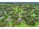 Magnificent aerial view of property with landscaping, backing onto a lush green golf course at 5714 Nw 80Th Avenue Rd, Ocala, FL 34482