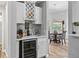 Stylish bar area with wine fridge, sink, and shelving, conveniently located near the dining room at 5714 Nw 80Th Avenue Rd, Ocala, FL 34482