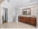 Elegant bathroom featuring wood cabinets, granite countertop, tile flooring, and natural light at 5714 Nw 80Th Avenue Rd, Ocala, FL 34482