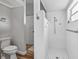 Bathroom with walk-in shower featuring white tile and updated fixtures at 5714 Nw 80Th Avenue Rd, Ocala, FL 34482