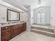 Luxurious bathroom with a soaking tub, granite countertops, and elegant finishes, creating a spa-like experience at 5714 Nw 80Th Avenue Rd, Ocala, FL 34482