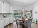 Cozy dining area features a round table and stylish chairs, with pool views visible through sliding glass doors at 5714 Nw 80Th Avenue Rd, Ocala, FL 34482