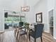 Modern dining room featuring a glass table, stylish chairs, and sliding glass doors to an outdoor patio at 5714 Nw 80Th Avenue Rd, Ocala, FL 34482